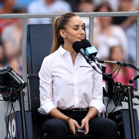 marijana sitting on the umpire chair wearing a white shirt and hair in a ponytail 